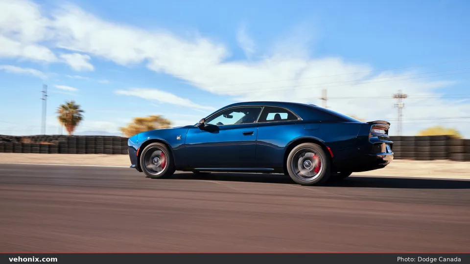 2026 Dodge Charger Daytona Scat Pack in Bludicrous blue, side profile on a track