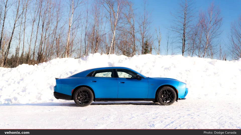 2026 Dodge Charger R/T in blue, full side profile on snow