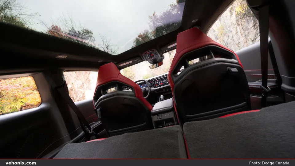 2026 Dodge Charger R/T cabin looking forward with panoramic roof and red seats
