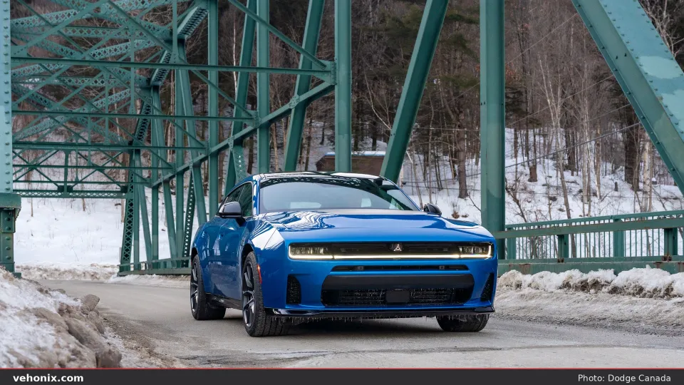 2026 Dodge Charger Scat Pack in blue, front three-quarter on a winding road