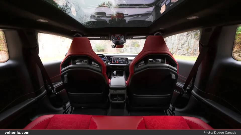 2026 Dodge Charger Scat Pack cabin looking forward over Demonic Red front seats