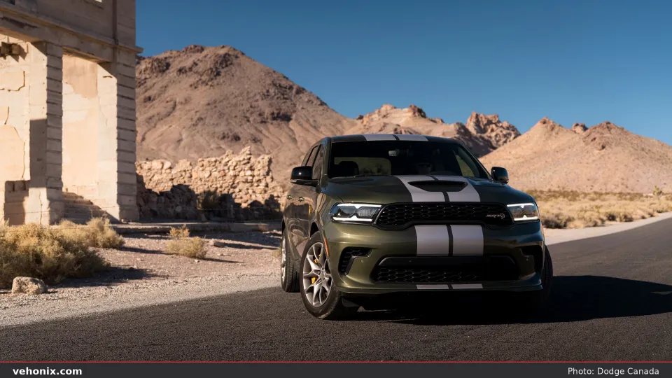 2026 Dodge Durango SRT Hellcat Jailbreak in Green Machine with silver stripes, front three-quarter in desert
