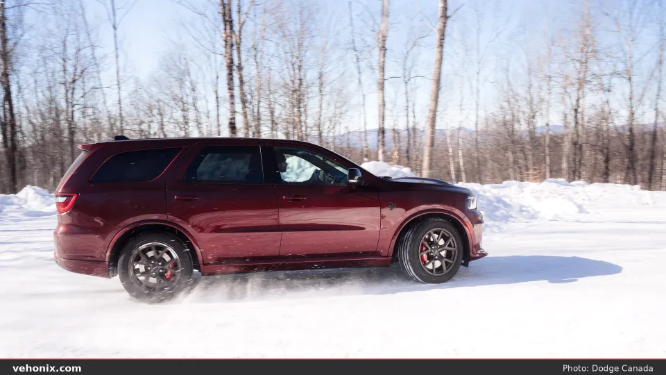 2026 Dodge Durango SRT Hellcat Jailbreak in Octane Red, side profile on snow