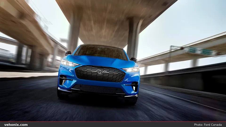 2026 Ford Mustang Mach-E® GT model being driven on a freeway with a blurred background