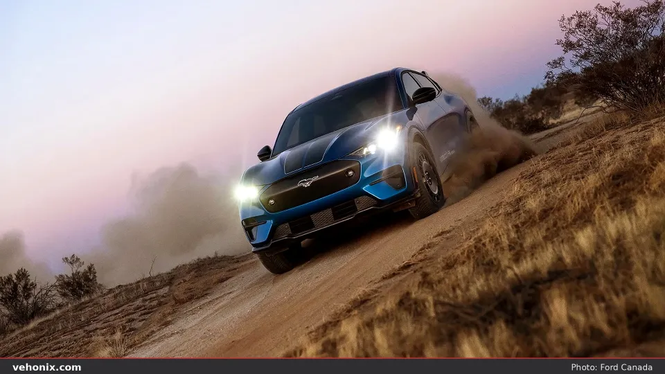 U.S. 2026 Ford Mustang Mach-E® Rally model being driven on a dirt road