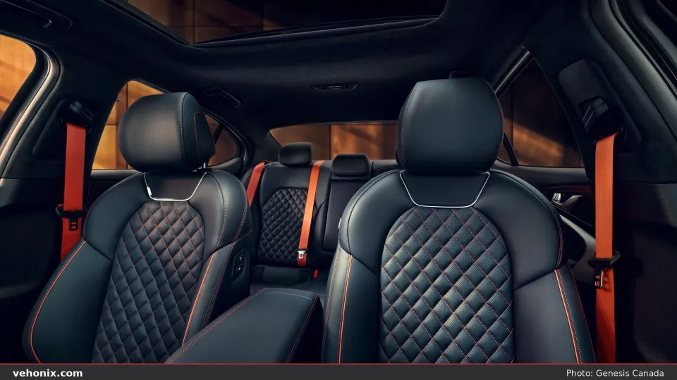 2026 Genesis G70 black quilted leather seats with bright red seatbelts
