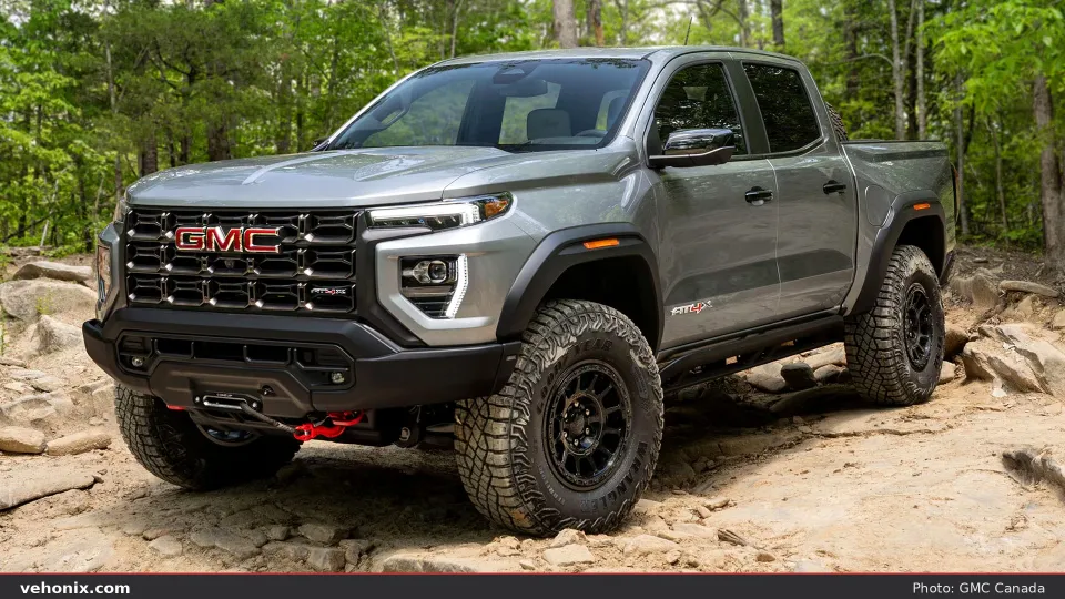 2026 GMC Canyon AT4X AEV in grey on a rocky trail with AEV bumper