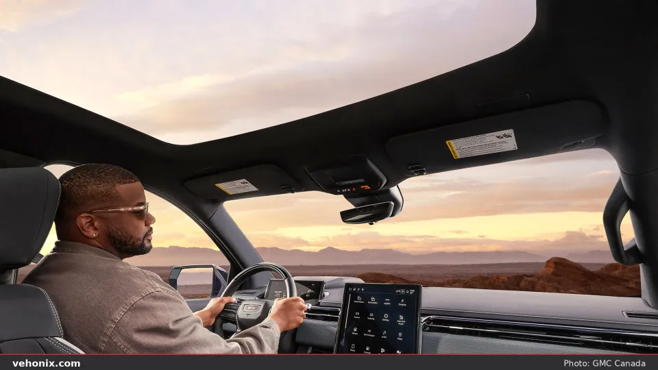 2026 GMC Sierra EV cabin with panoramic sunroof looking rearward