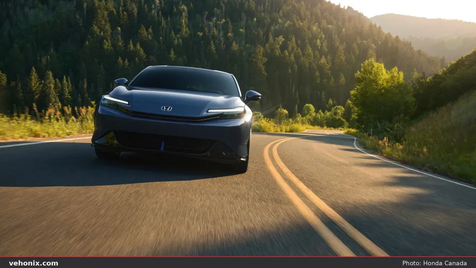 2026 Honda Prelude in blue, front three-quarter driving on a mountain road