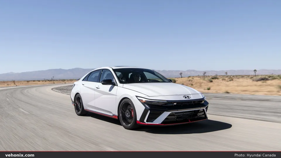 2026 Hyundai Elantra N in white, front three-quarter driving on a desert road