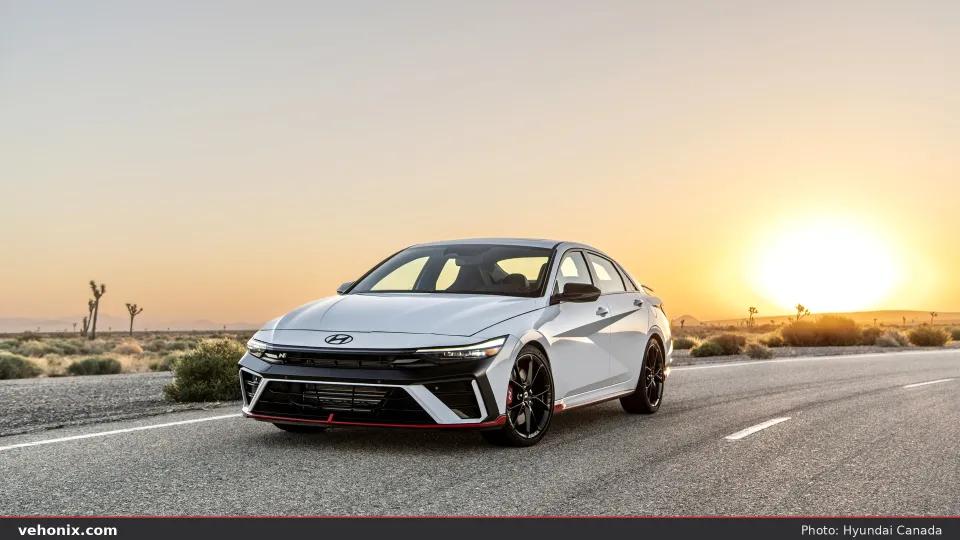 2026 Hyundai Elantra N in white, front three-quarter on a desert road at sunset
