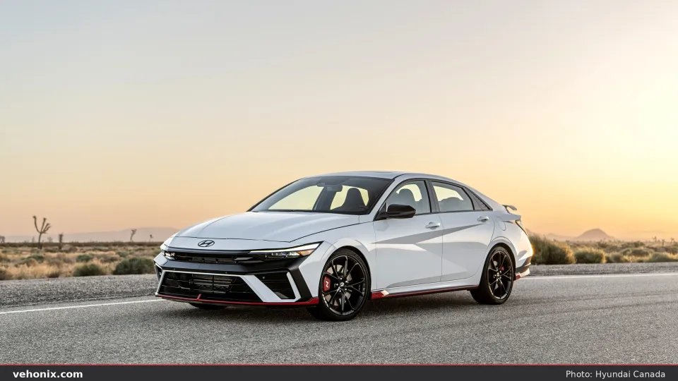2026 Hyundai Elantra N in white, front three-quarter with red lip and black wheels