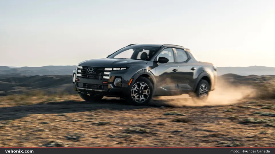 2026 Hyundai Santa Cruz XRT, front three-quarter action on a dirt trail
