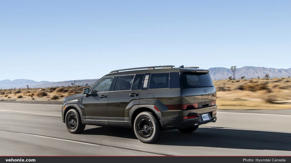2026 Hyundai Santa Fe XRT in dark green, side profile on a forest trail