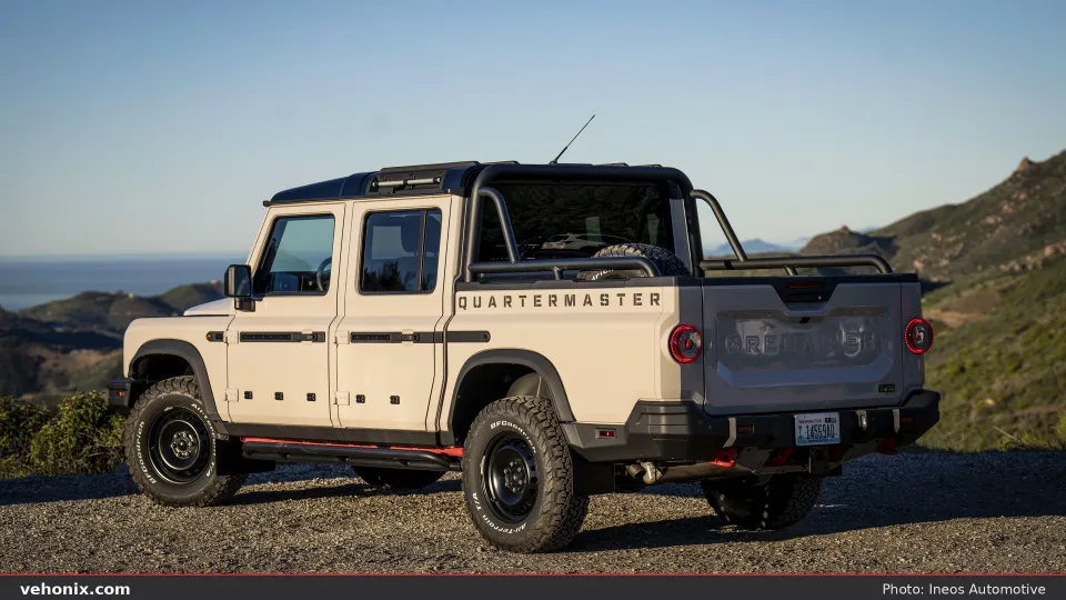 2026 Ineos Grenadier Quartermaster in tan, rear three-quarter exterior