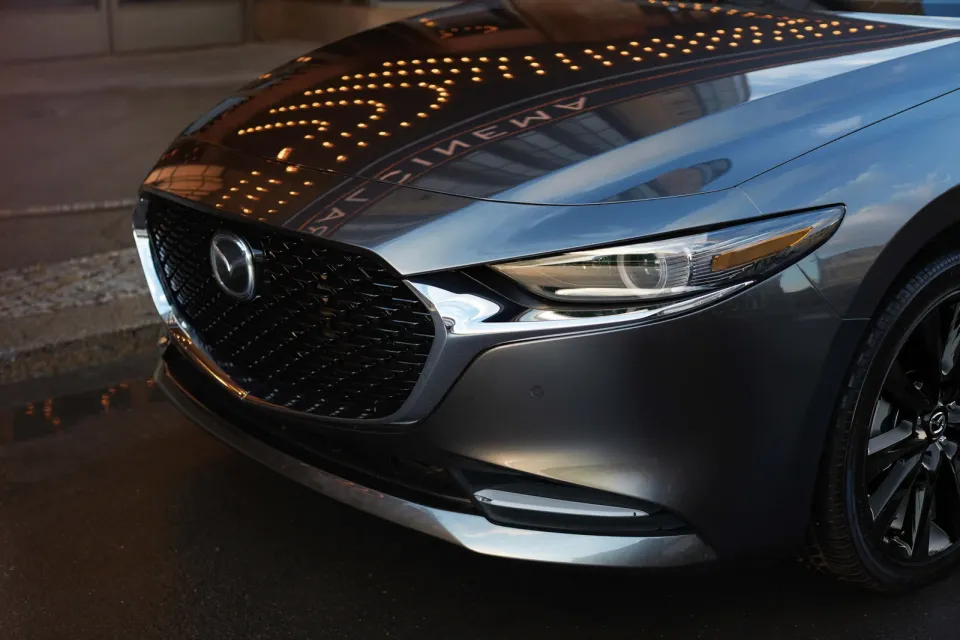 Close view of the 2026 Mazda3 front grille and headlight