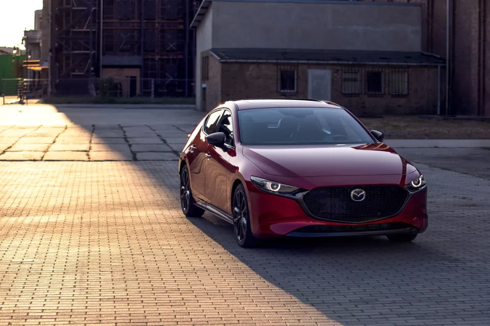 2026 Mazda3 Sport hatchback in red, front three-quarter view