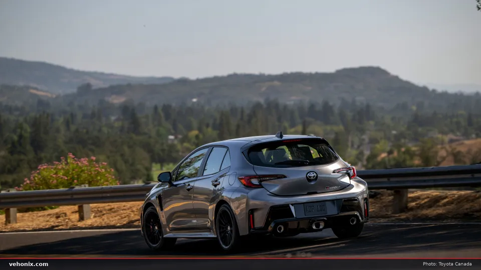 2026 Toyota GR Corolla Premium Plus in grey, rear three-quarter view with hills behind