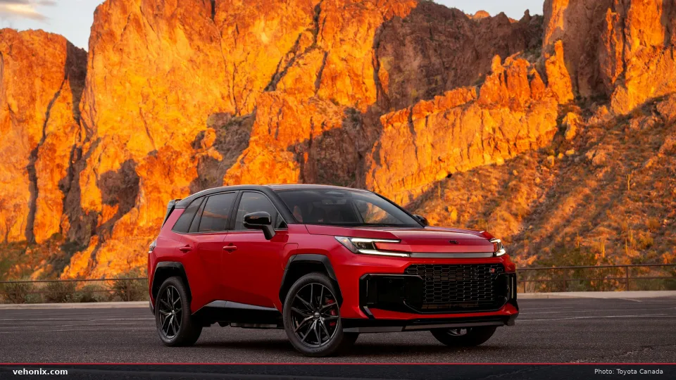 2026 Toyota RAV4 GR SPORT PHEV in Supersonic Red, front three-quarter view by red cliffs