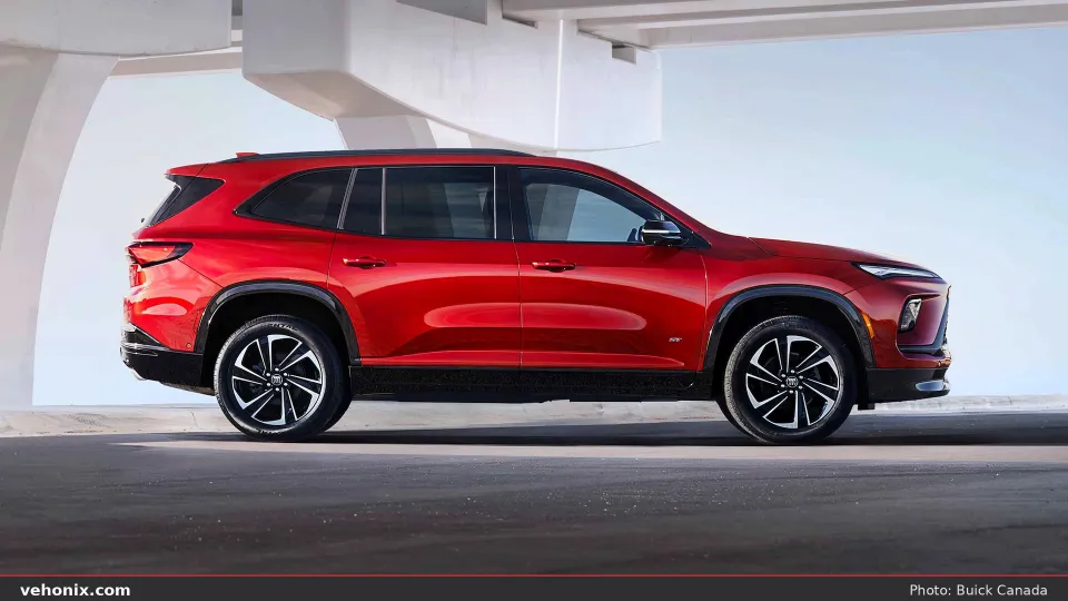 2026 Buick Enclave ST in red, full side profile under a white concrete overpass