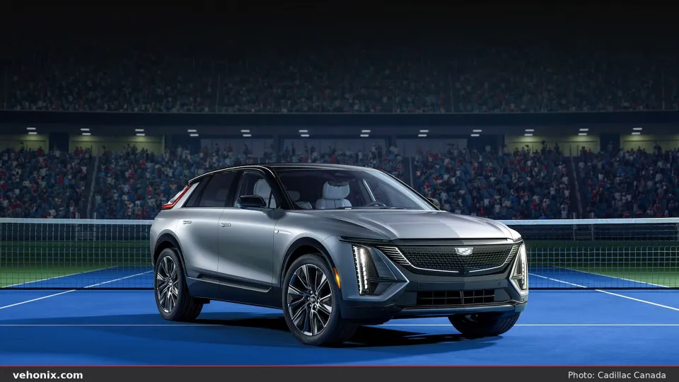 2026 Cadillac LYRIQ in silver on a blue tennis court with stadium seating behind