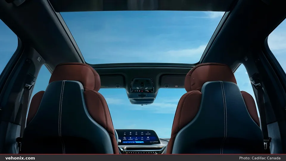 2026 Cadillac LYRIQ panoramic glass roof and two-tone front seats under blue sky