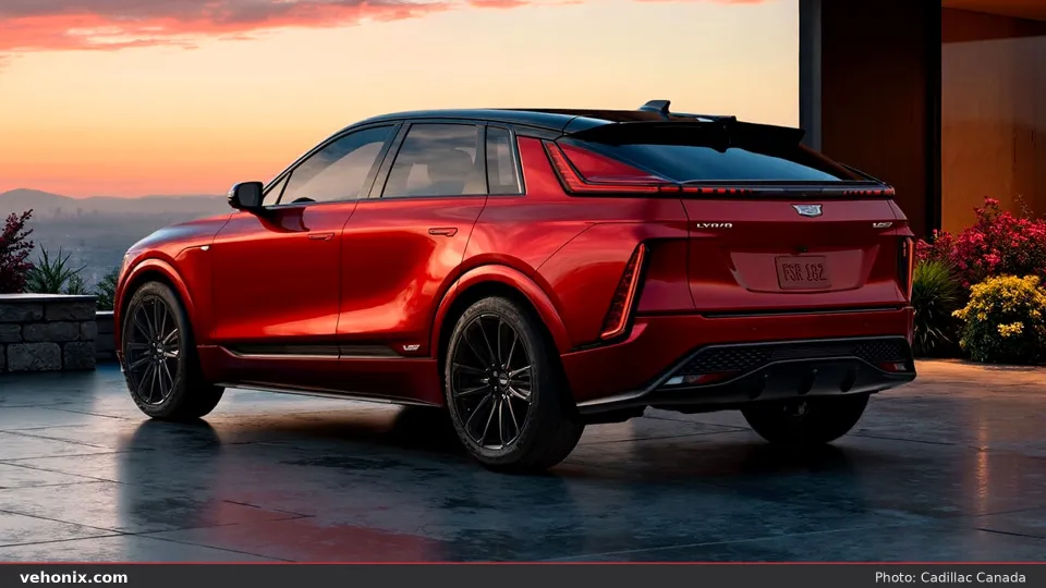 2026 Cadillac LYRIQ-V in red, rear three-quarter at dusk overlooking a city