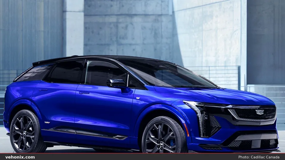 2026 Cadillac OPTIQ-V in electric blue, front three-quarter against concrete walls