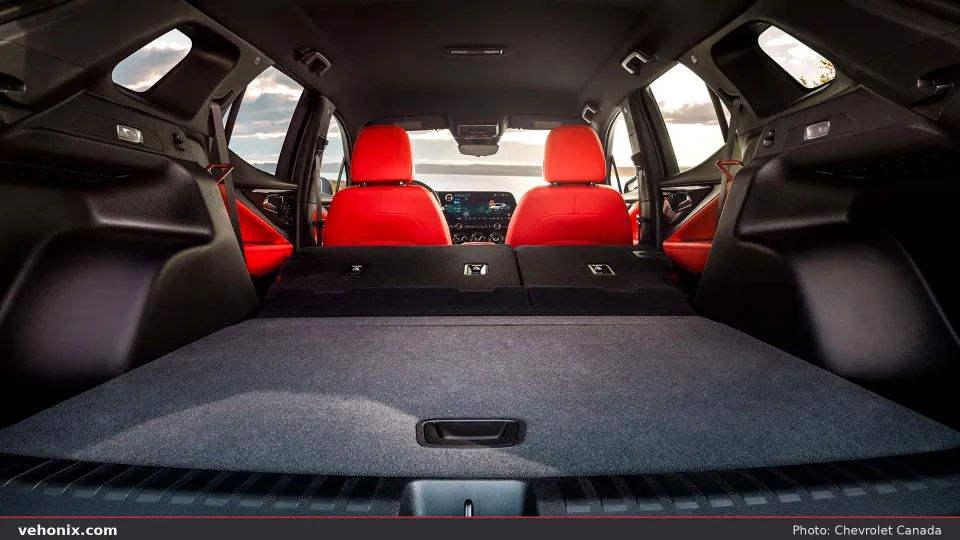 2026 Chevrolet Blazer EV cargo area with rear seats folded and red front seats