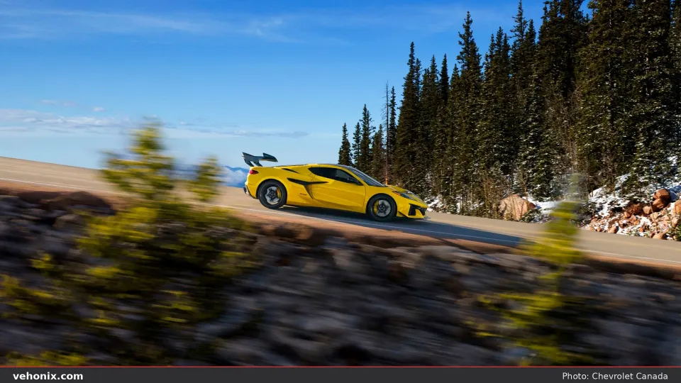 2026 Chevrolet Corvette ZR1 in yellow, side profile on a mountain road