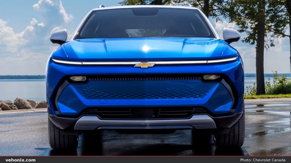 2026 Chevrolet Equinox EV in blue, front view by water with a white roof