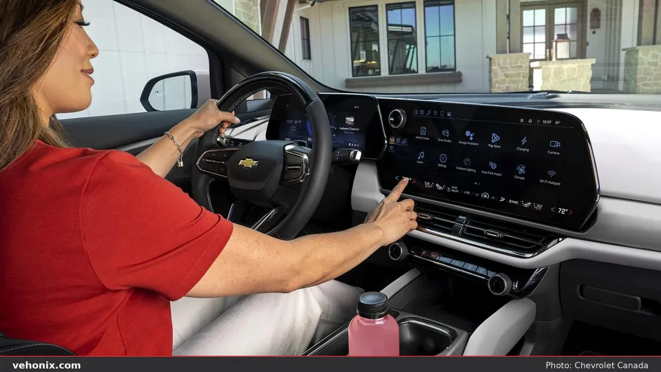 2026 Chevrolet Equinox EV, driver using the centre touchscreen