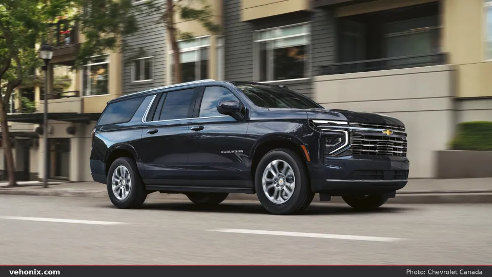 2026 Chevrolet Suburban in black, front three-quarter view on a city street