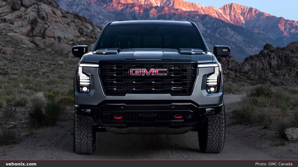 2026 GMC Sierra AT4X in silver, front view with red recovery hooks