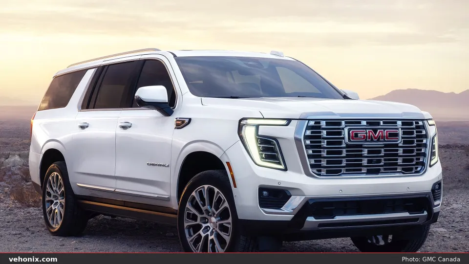 2026 GMC Yukon XL Denali in white, front three-quarter in desert light