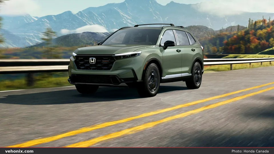 2026 Honda CR-V TrailSport Hybrid in Ash Green on a mountain road