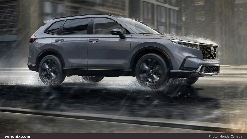 2026 Honda CR-V in Meteorite Gray, side profile driving through rain in the city