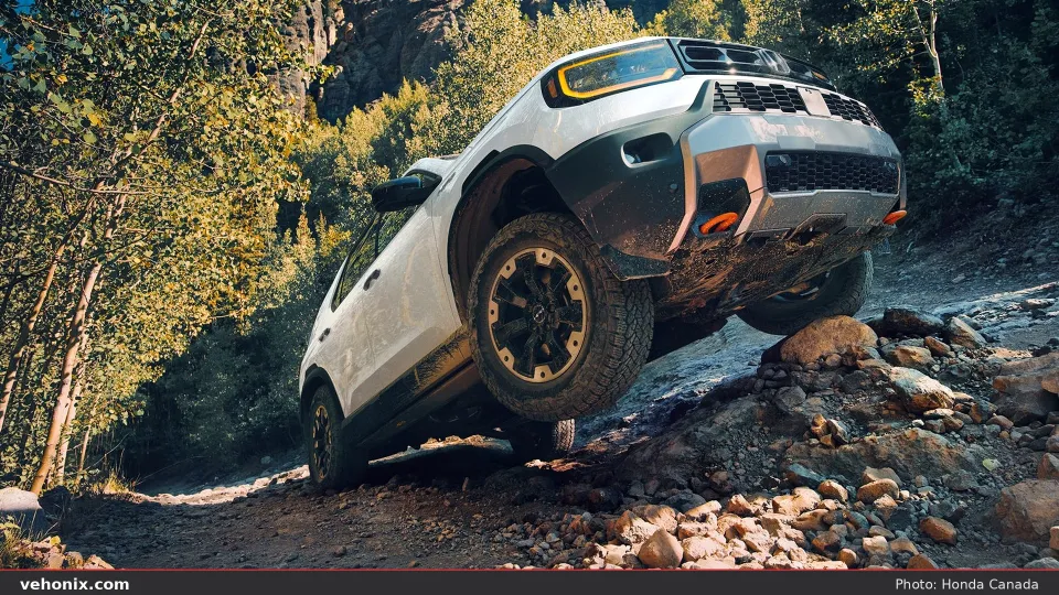 2026 Honda Passport TrailSport Elite in Platinum White Pearl climbing rocky trail