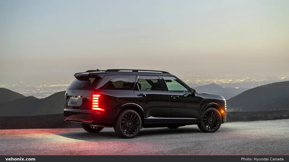 2026 Hyundai Palisade dark exterior, three-quarter view near rocky terrain