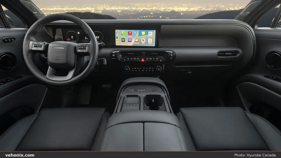 2026 Hyundai Palisade dual-screen cockpit with city lights through the windshield