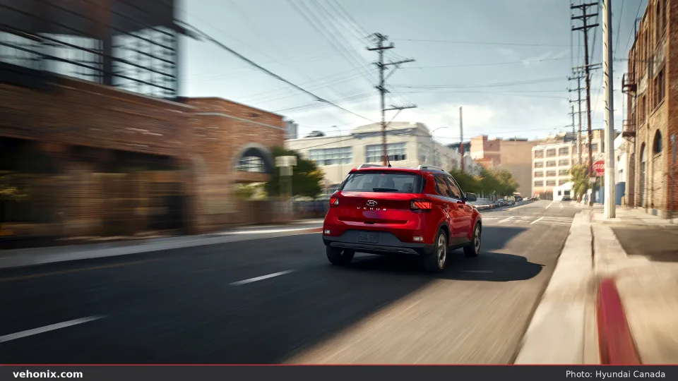 2026 Hyundai Venue in grey, front three-quarter in a coastal city setting