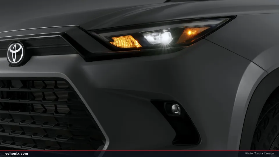 2026 Toyota Grand Highlander Woodland close-up of the headlight and grille
