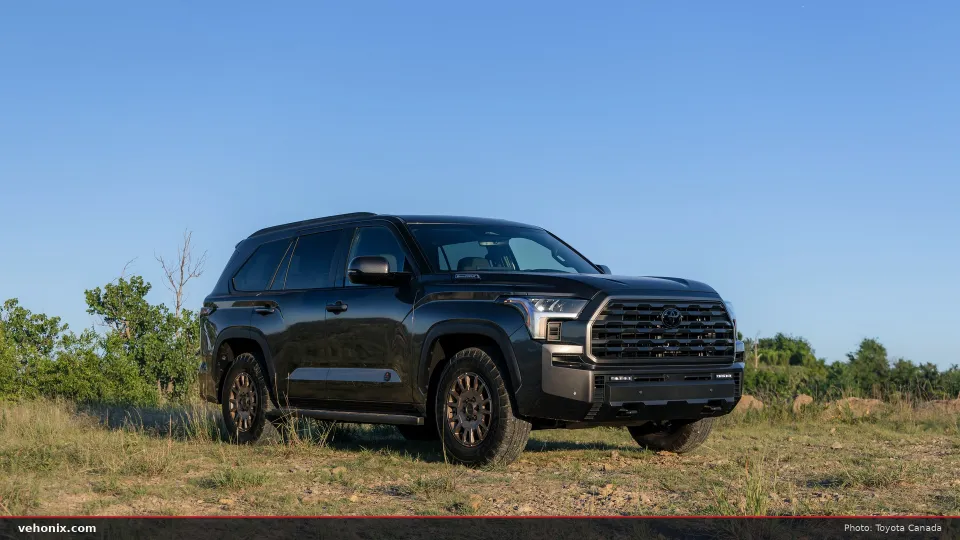 2026 Toyota Sequoia Trailhunter in dark grey, front three-quarter view in a field