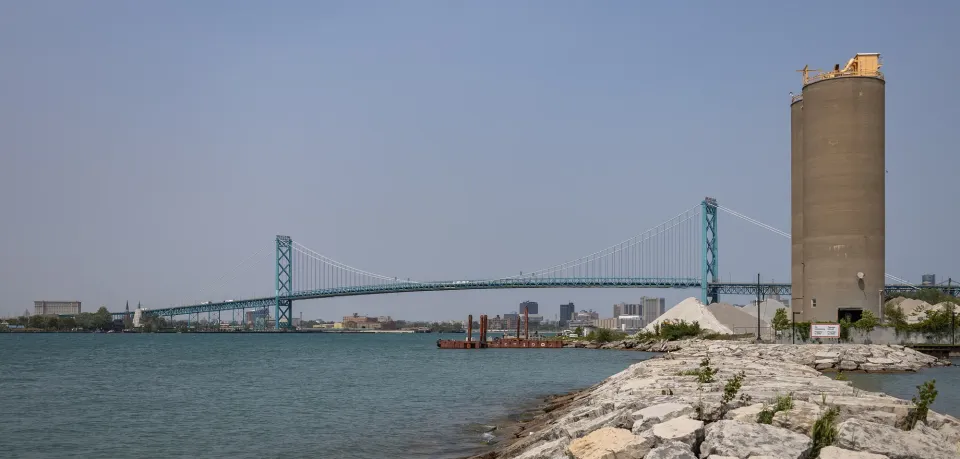 The Ambassador Bridge stretching across the Detroit River from Windsor, Ontario, with the Detroit skyline behind it