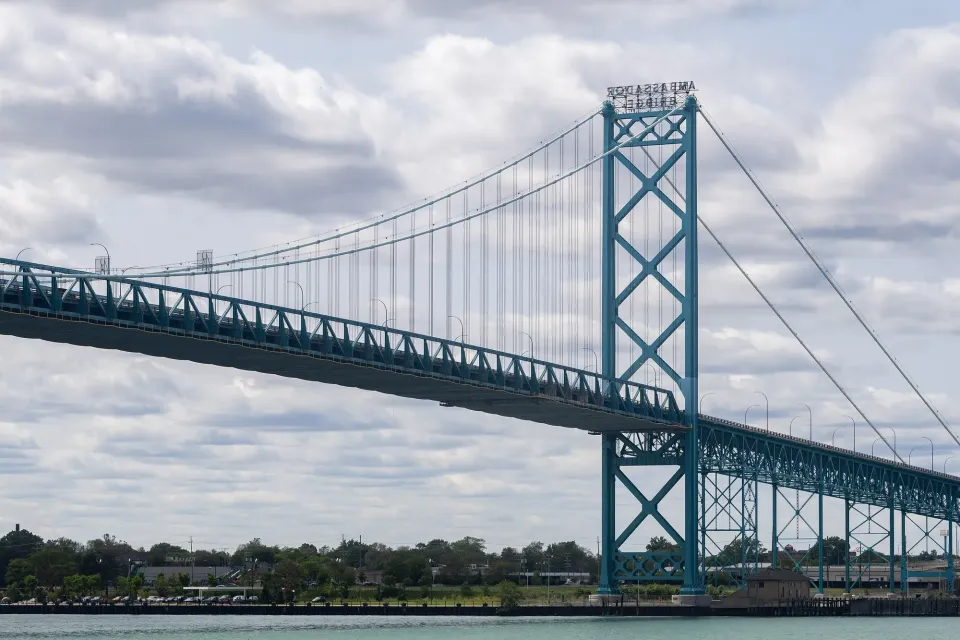 The Ambassador Bridge between Windsor, Ontario and Detroit, seen across the Detroit River on a cloudy day