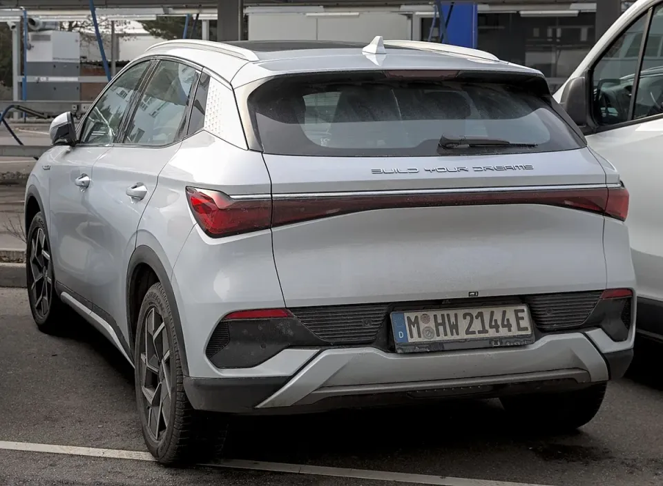 A silver BYD Atto 3 electric SUV seen from the back in Europe