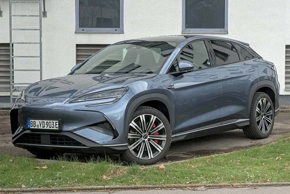 A grey BYD Sealion 7 electric SUV parked outside, seen from the front left