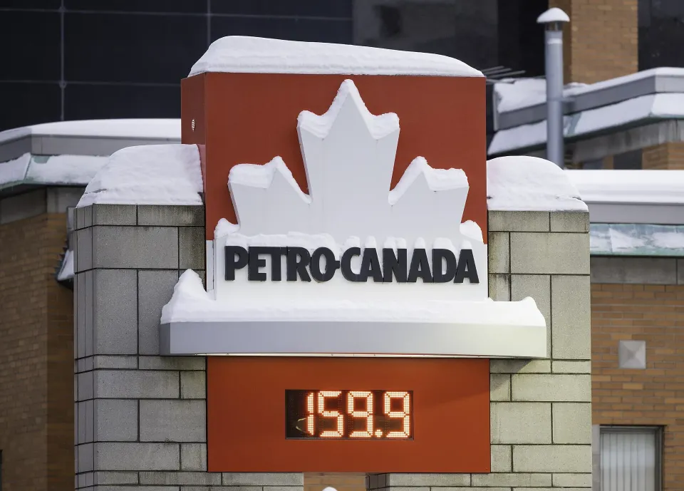 Une enseigne Petro-Canada au Québec couverte de neige, avec un prix de l'essence de 159,9 à l'affiche