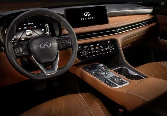 Infiniti QX60 dashboard with steering wheel, touchscreen and tan leather trim