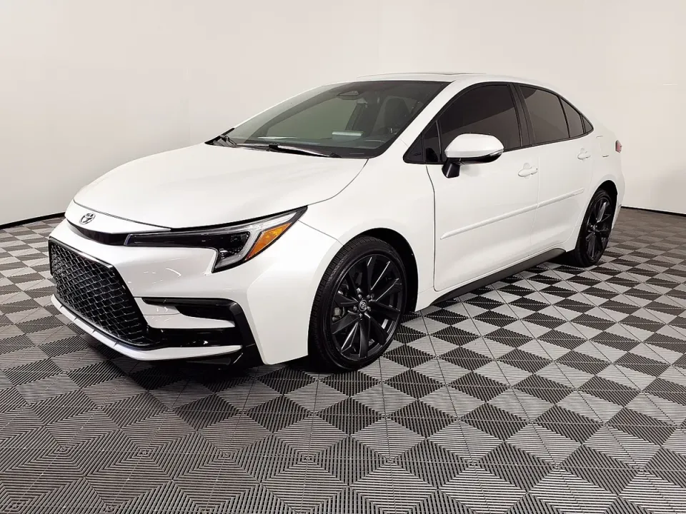 A white Toyota Corolla Hybrid in a showroom